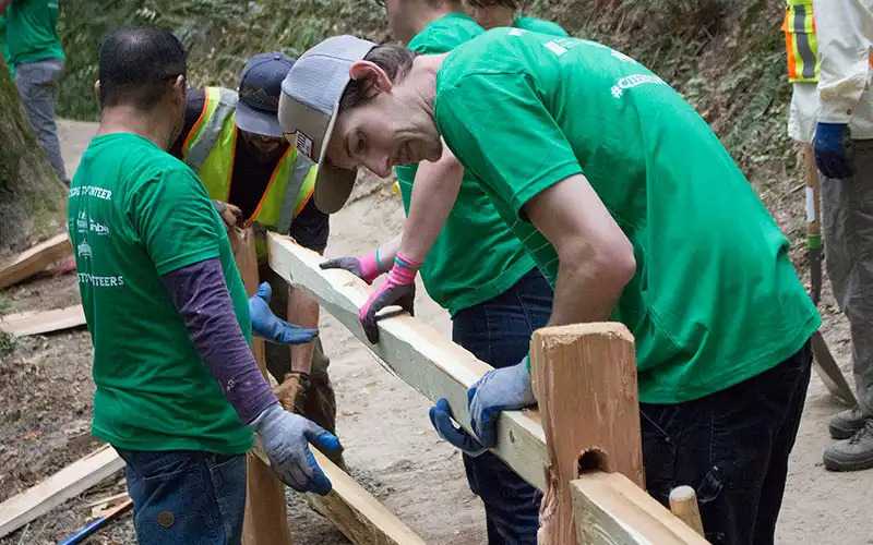 Two people cleaning up their park